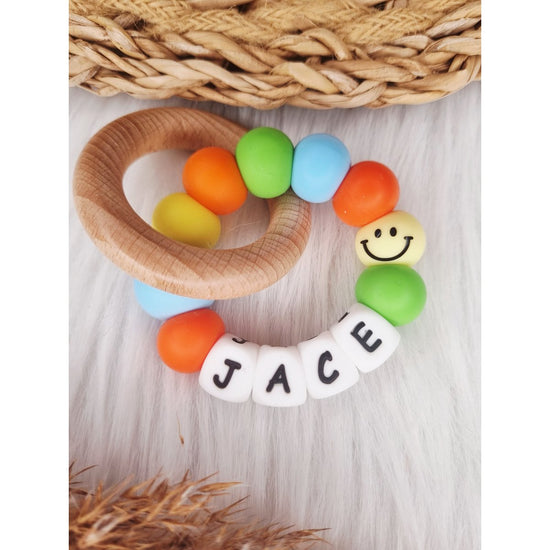 Bijtring met naam Smiley babyblauw
